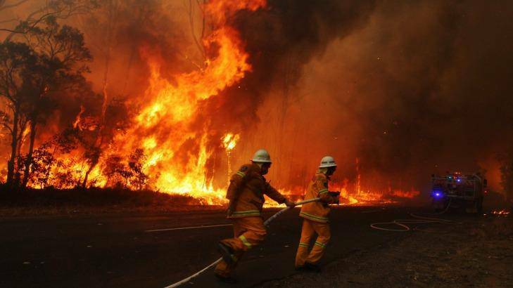 Firefighters battle a blaze in the Blue Mountains in September, 2013, a month of "unprecedented" high temperatures. Photo: Nick Moir