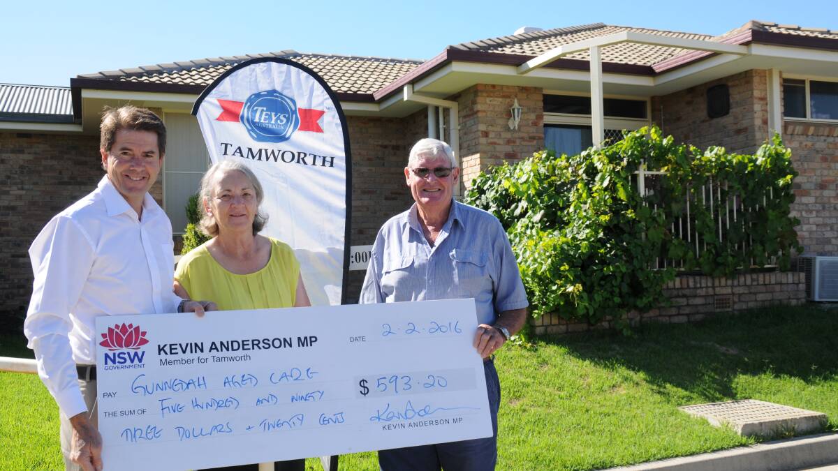 Another step towards a bus: Member for Tamworth Kevin Anderson hands over a cheque for $593.20 to Gunnedah Aged Care Services chief executive officer Sandra Strong and Gunnedah Aged Care Services board chairman John Perkins.