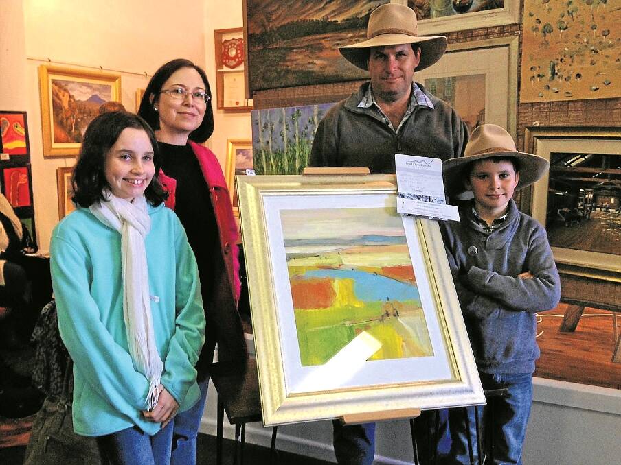 CURLEWIS artist Maree Kelly won Frost Over Barraba’s major prize last weekend –  the New England Mutual Acquisitive Prize of $2500 was awarded for Maree’s work, Patchwork Lake, of Goran Lake, near Spring Ridge. Maree is pictured with husband Stephen, daughter Darcy and son Goran at the exhibition.