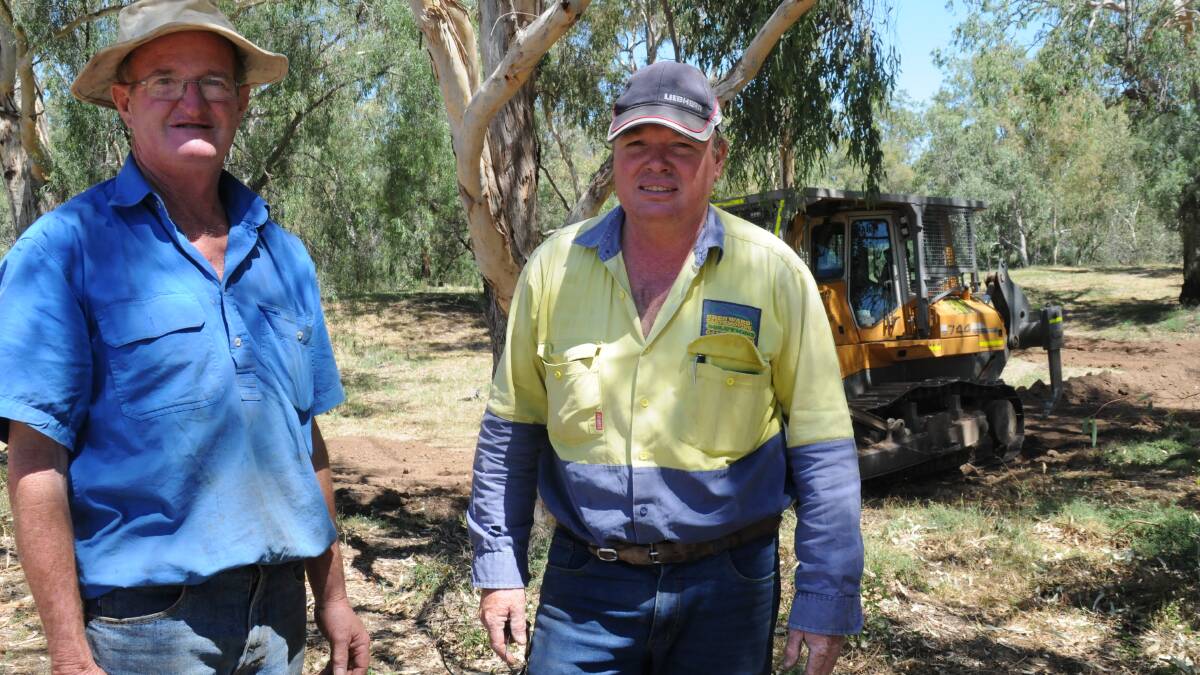 Gunnible Landcare chairman Geoff Hood with earthmoving contractor Greg Ward during work on the Namoi riverbank.