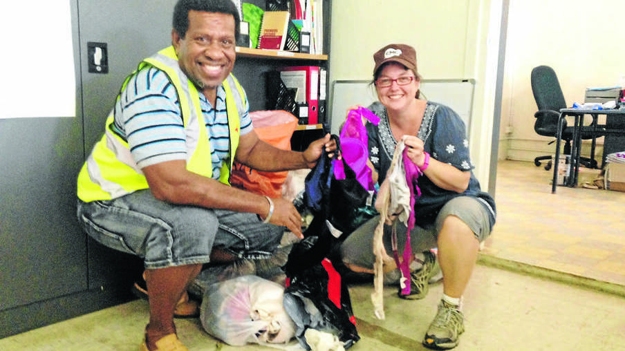 BAGS OF SUPPORT: Vanuatu Red Cross acting chief Augustin Gara with Rebecca Belt and bags of 680 bras at the charity s headquarters in Port Vila. Photo: Ruth Caskey