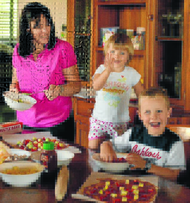 Carla McInnes in the kitchen with her children Ava (4) and Matthew (7).