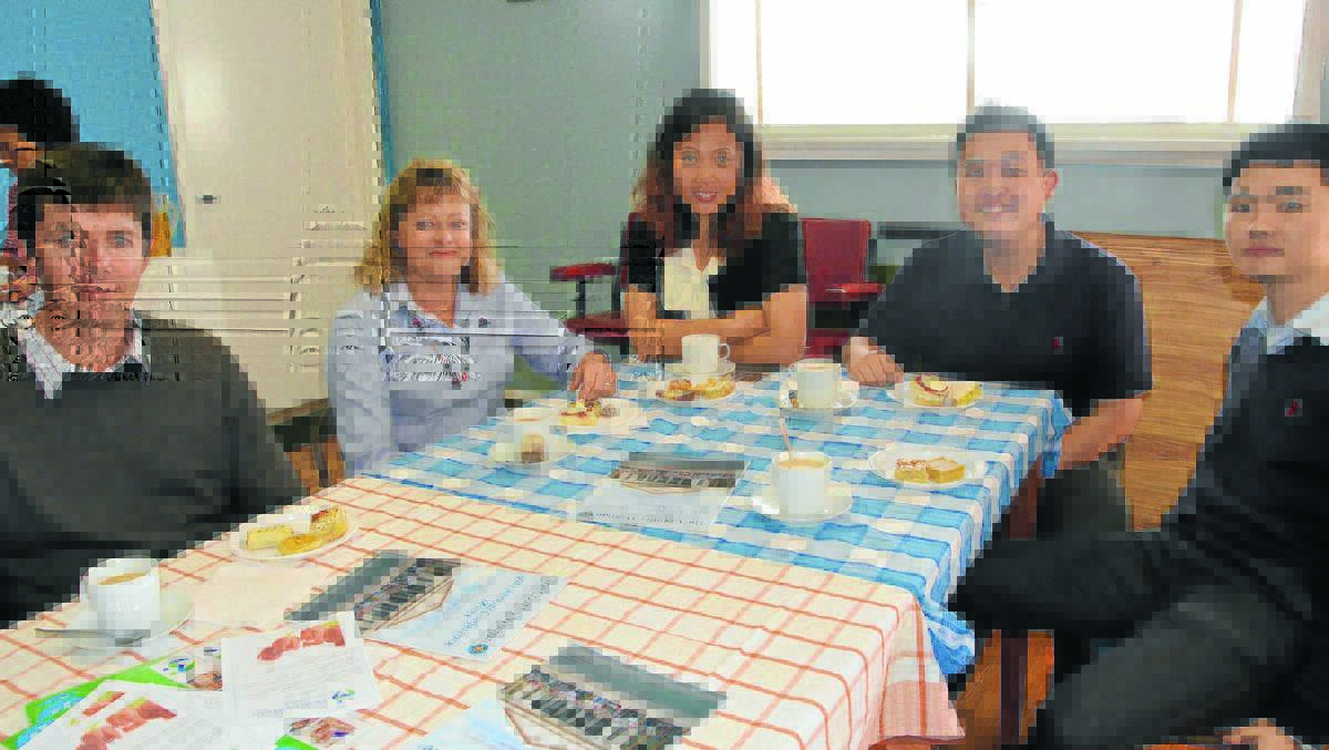 Meals on Wheels volunteers enjoyed morning tea with Shenhua staff, from left, Grayson Wolfgang, Trish Easey, Kathy Wu, Joel Zhao, Wu Chao.