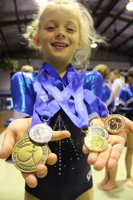 Level 1 Gunnedah gymnast Stella Robertson with her swag of medals.
