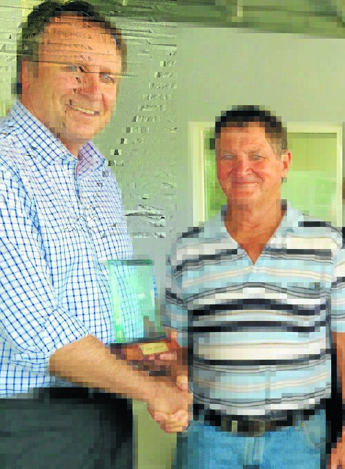 Col Gillham (left) is presented with his award by Member for Barwon Kevin Humphries.