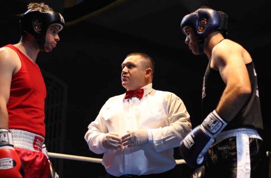 Jordy Ford (right) meets with the referee and opponent Sean Clark before the fight.