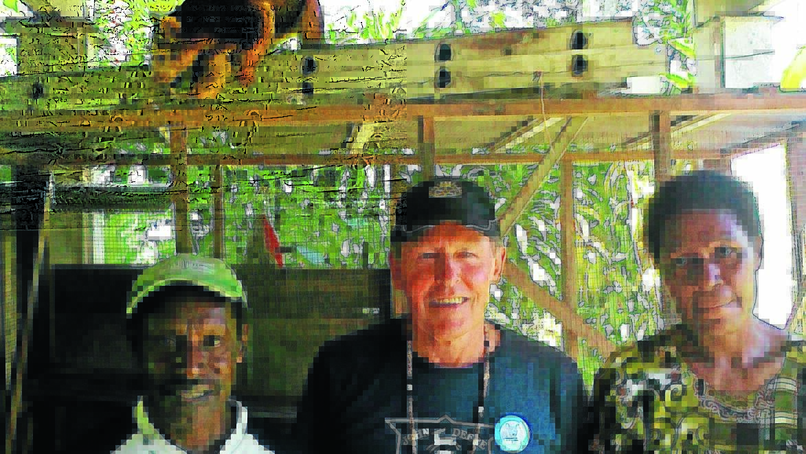 Leon Simes, Rod Browne and Julia Simes in Kokoda, Papua New Guinea with a tree kangaroo and Gunnedah’s Project Koala badges.