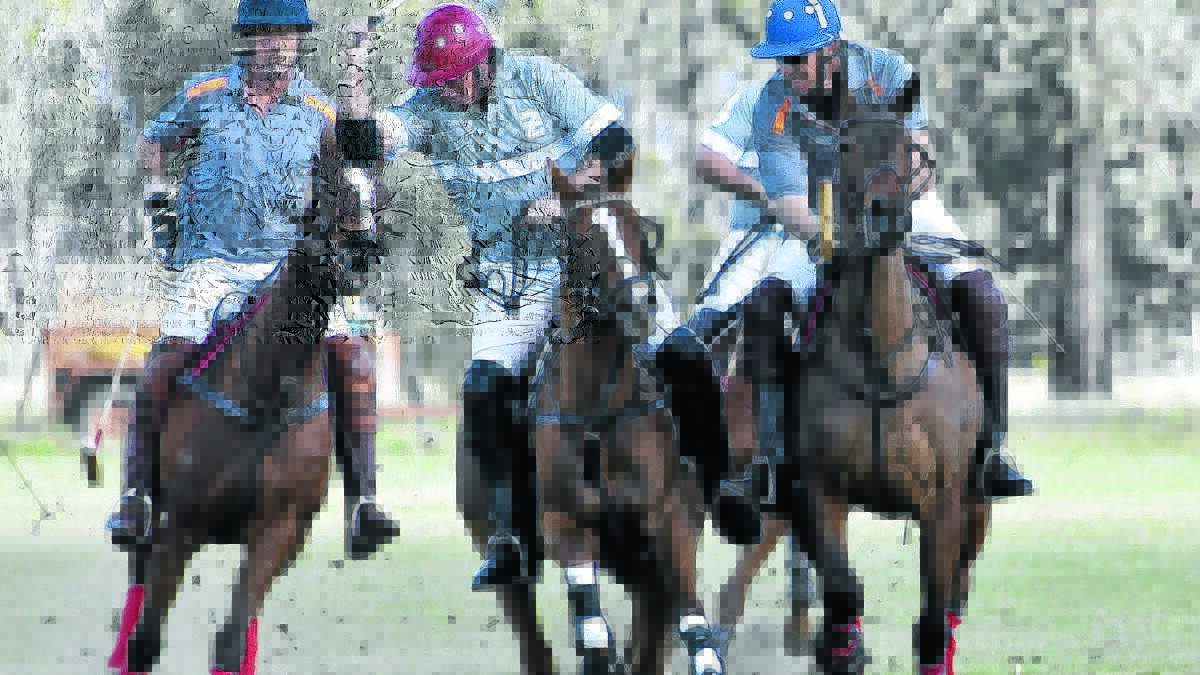 The action was fast and furious at the annual Gunnedah Polo Club carnival on Saturday. Pictured, from left, are Angus Scott, Glen Gilmore and Scott McCreery. Picture: Les Alker.
