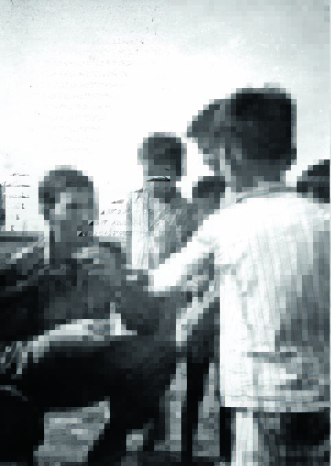 Gunnedah conscript Colin Clarke did two tours of duty Vietnam. He is pictured chatting with local children on Long Son Island, an isolated and then unfriendly island off the Vietnam Coast.