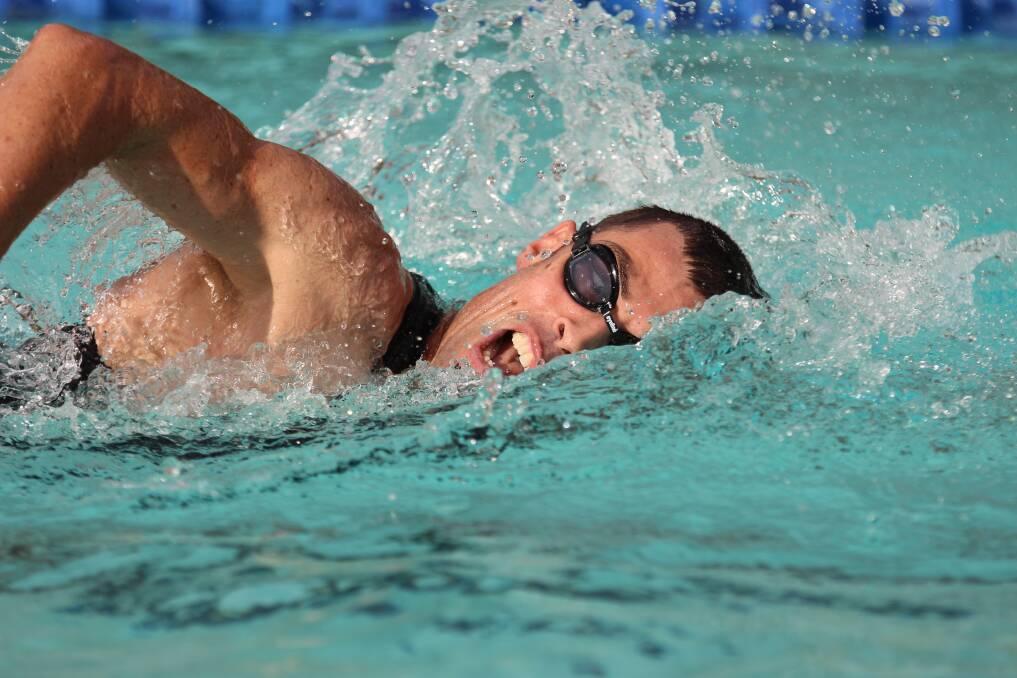 Pete Loveridge carves up the pool in the men's triathlon on Monday.