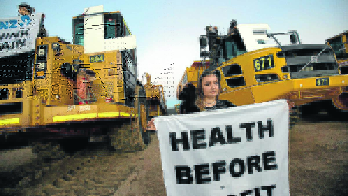 Protestors chained themselves to large machinery and held banners after a protest at the Maules Creek coal mine site intensified yesterday. 