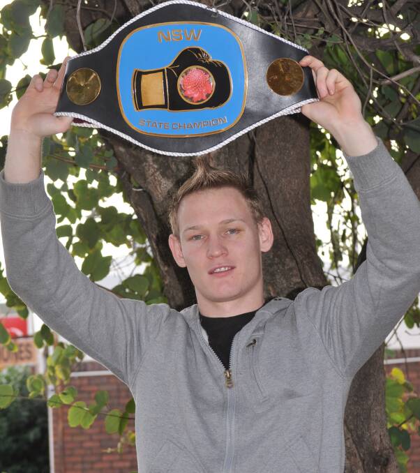 Former Gunnedah boxer, Kye MacKenzie with his championship belt after winning the NSW Super Featherweight Title 