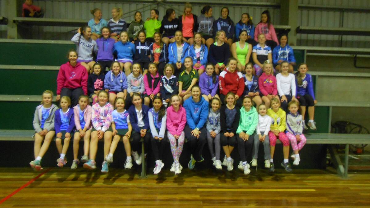 Juniors at the netball skills session in Gunnedah with Sydney Swifts players Abbey McCulloch (pink jumper, second row from bottom) and Susan Pettitt (nee Pratley) (blue jumper, front row).