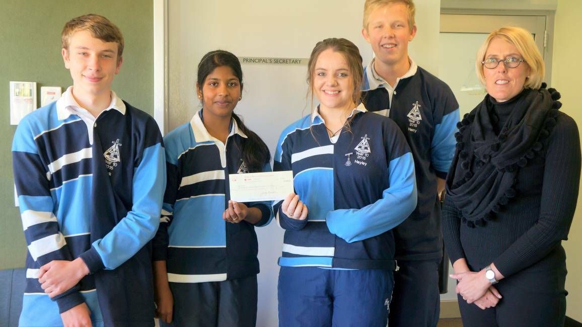 DONATION: Year 10 students Jack Stader, Harry Jorgensen, Littisha Varghese and Hayley Duffy with Holy Trinity principal Jillian Rainger and the cheque for $1102.70.