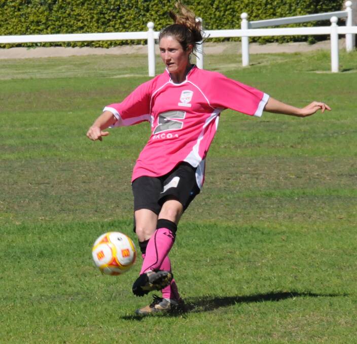 LET'S GET OUT OF HERE: Namoi's Angela Pattison clears the ball for the Invitational team during its 4-0 loss to a Tamworth line-up in Saturday's women's All-Stars soccer match at Narrabri.