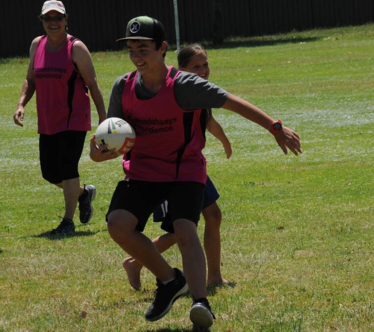 HAVING A GOOD TIME: Brodie Riley enjoys his time in possession during the annual family touch football gala day on Saturday.