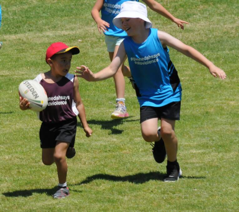 DYNAMITE: Malaki Winsor about to be touched as he makes a long run during the annual family touch football gala day at Rugby Park.