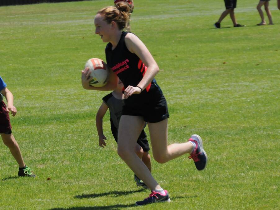 HAVING A RUN: Chloe Sumpter evades the opposition defence during the annual family touch football gala day at Rugby Park on Saturday.
