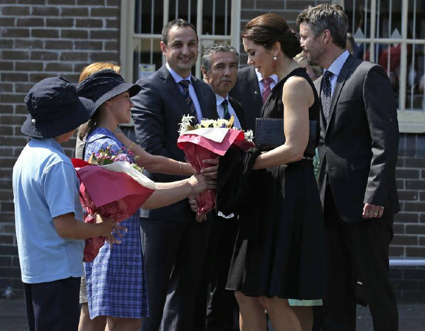 Denmark's and Crown Princess Mary, second right, is presented flowers by grade 6 student Lauren Miniaci, second left, as the princess and Crown Prince Frederick, right, arrive at Five Dock Public School. Photo: Rick Rycroft