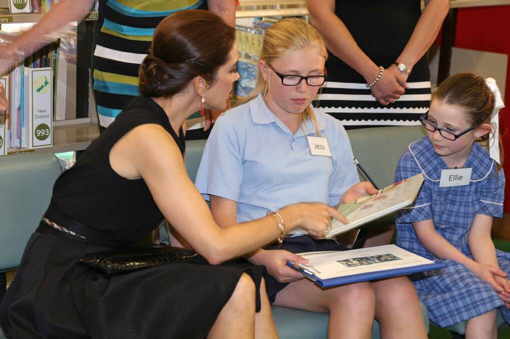 Denmark's Crown Princes Mary, left, chats with students Jessica McKee and Allie Barnett, right, during a reading lesson as the princess and Prince Frederik visit Five Dock Public School. Photo: Rick Rycroft