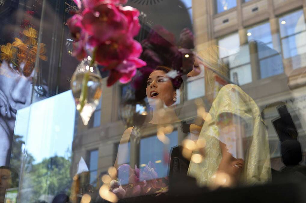 Denmark's Crown Princess Mary, center, is photographed through a glass display case as she attends the official opening of Ole Lynggaard jewelry store in Sydney. Photo: Saeed Khan
