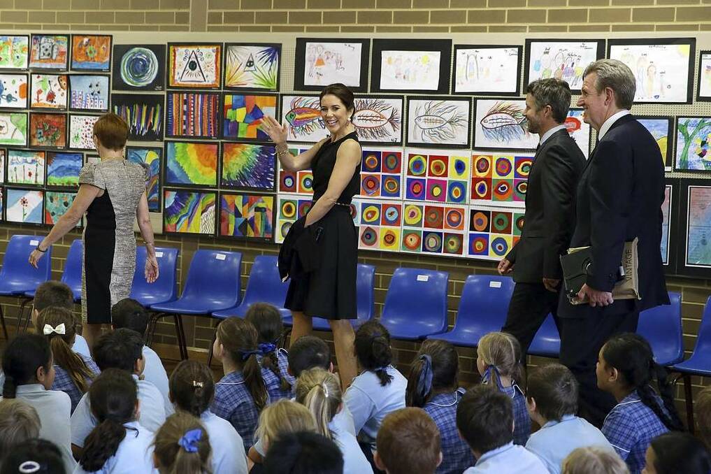 Denmark's Crown Princess Mary waves to school children as she arrives at the Five Dock Public School with her husband Denmark's Crown Prince Frederik (2nd R) and other officials in Sydney. Photo: Brendan Thorne