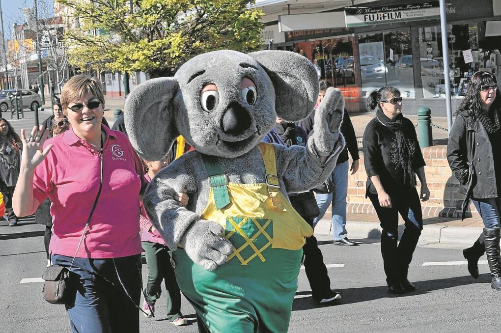 SMILEY the koala was a popular addition to the parade down Conadilly Street on Sunday morning. Smiley is pictured with Liz Riordan.