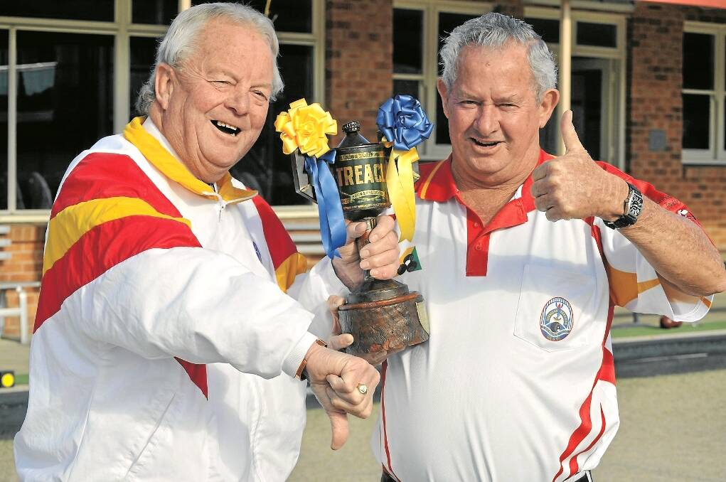 Allan Hillier, left, at least found some humour in handing over the Treacle Tin trophy to Leo Riley at Gunnedah Services and Bowling Club on Sunday. 
