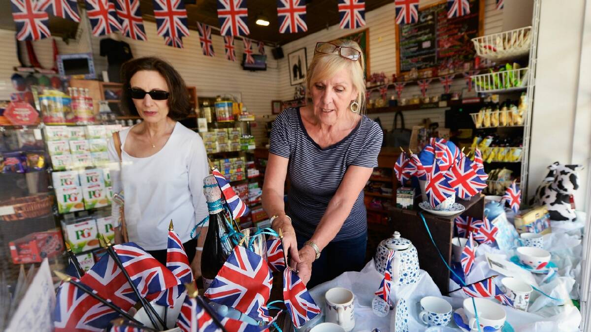 Linda Roberts (right) dresses her shop window with flags and baby blue colors to celebrate the announcement of the birth of Catherine, Duchess of Cambridge, and her husband Prince William's first child. Picture: Getty 