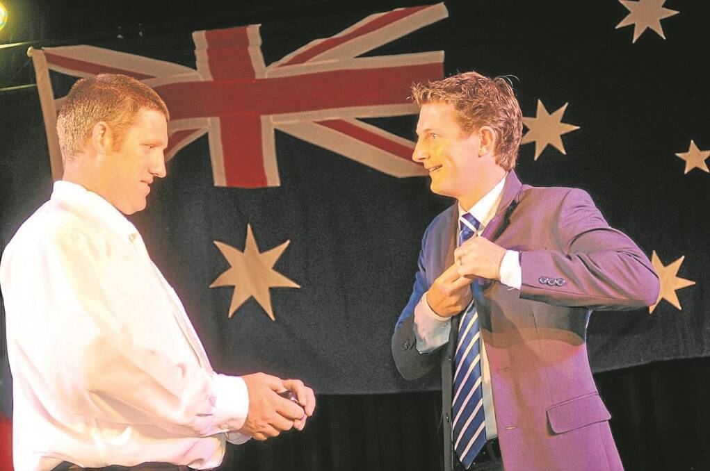 WOOLWORTHS representative David Brown, left, presenting the official Australia Day Ambassador pin to Michael Crossland. Woolworths has sponsored the program for the past seven years.