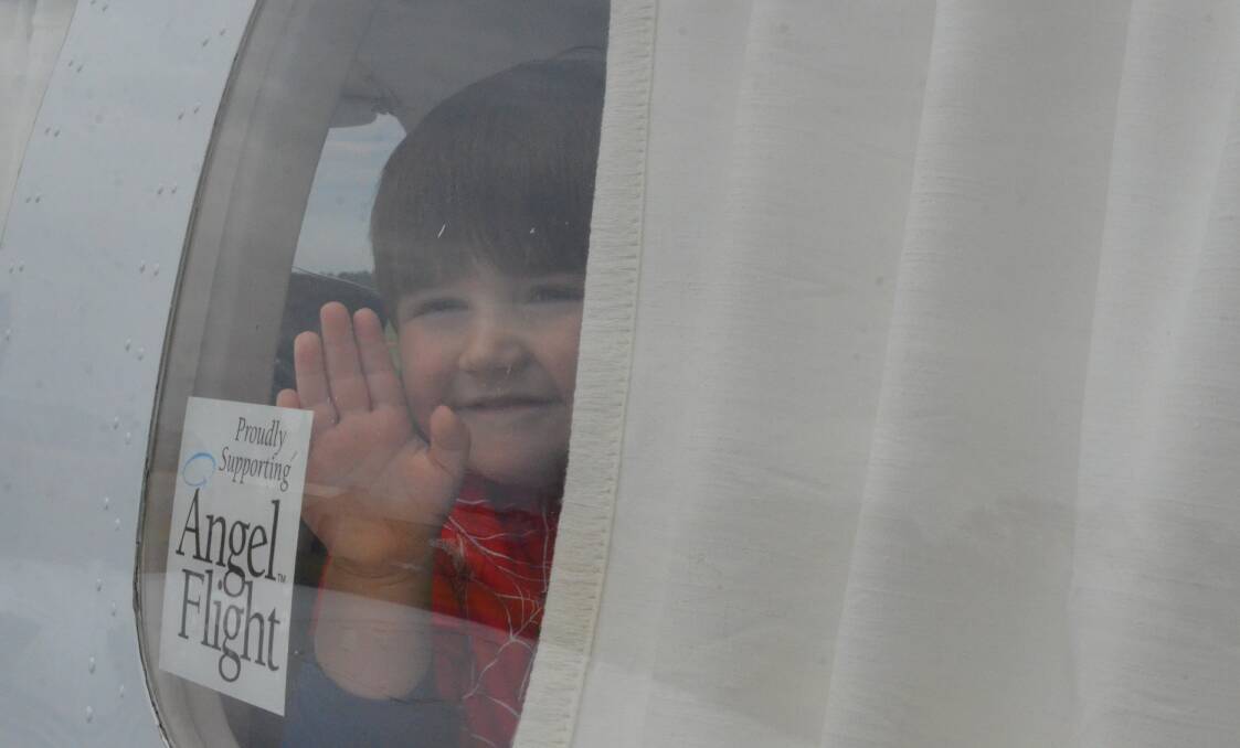 Memphis Francis, 3, waves goodbye to his grandparents Mark and Alex Facer onboard his Angel Flight to Queensland on Friday morning. PHOTO: Cai Holroyd