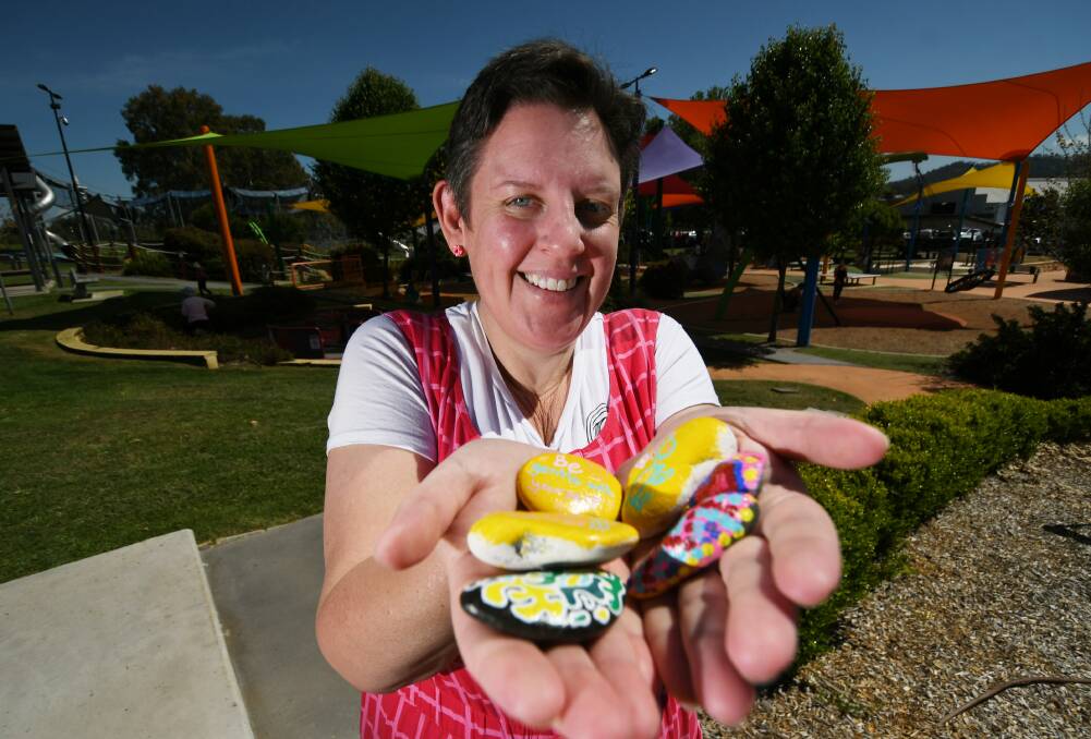 READY TO ROCK: Jody Ekert with her painted rocks as NSW reopens according to the roadmap. Photo: Gareth Gardner 081021GGD03