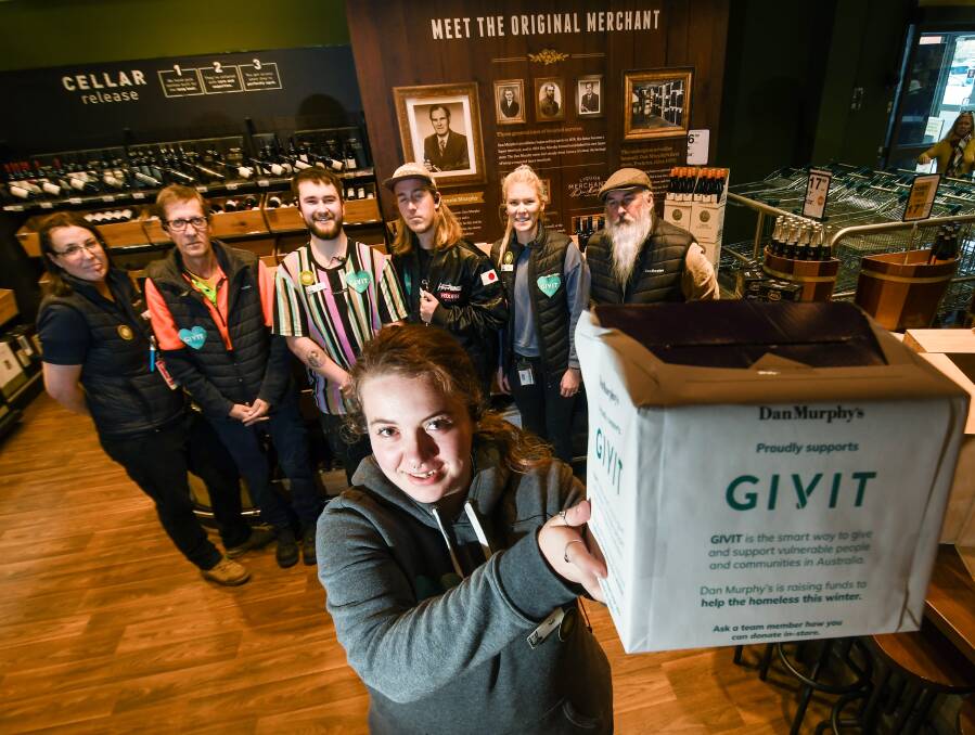 Nat Bedford and staff at Tamworth Dan Murphy's with their GIVIT box. Picture by Gareth Gardner