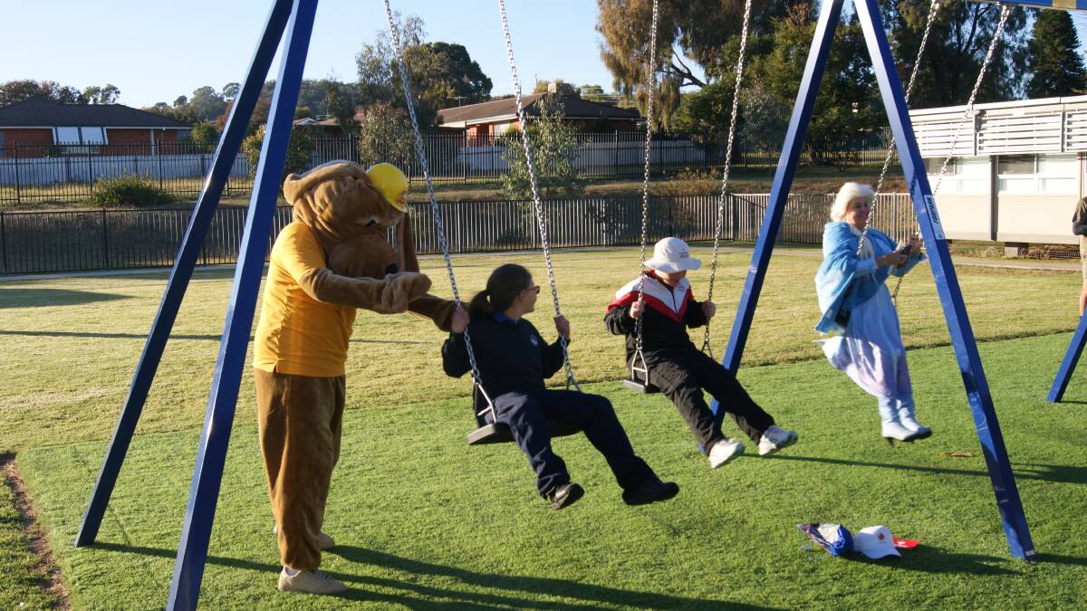 All smiles: Mizzi family playing on the swingsets that were purchased with the $5000 Variety grant. Photo: Supplied.