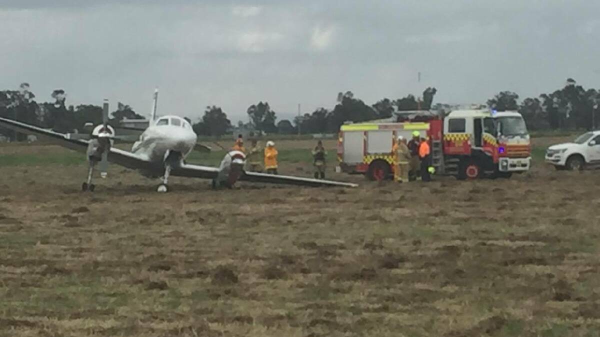 Crash scene: Emergency services at Gunnedah Airport on Thursday afternoon after the light plane crashed during takeoff. Photo: Peter Hardin