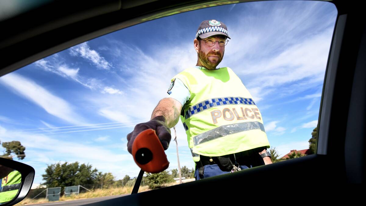 On patrol: Senior Constable Anthony Simshauser at an RBT. Police are preparing for extra testing during the busy public holiday period. Photo: Gareth Gardner