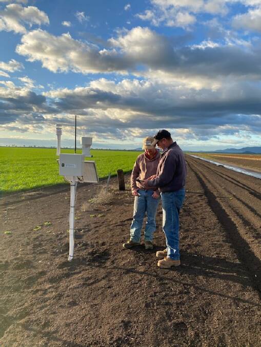 CUTTING EDGE: Jock and Dave Tudgey from Tudgey Farms, Breeza, inspecting a weather station.
