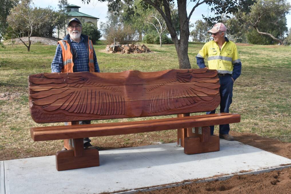 Woodturner Dan Birkett and Peter Haley with the new timber seat at Pensioners. Photo: supplied