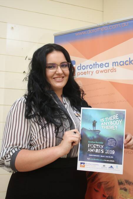 Dorothea Mackellar Poetry Competition officer Brittany Riley with a collection of published poems from 2018.