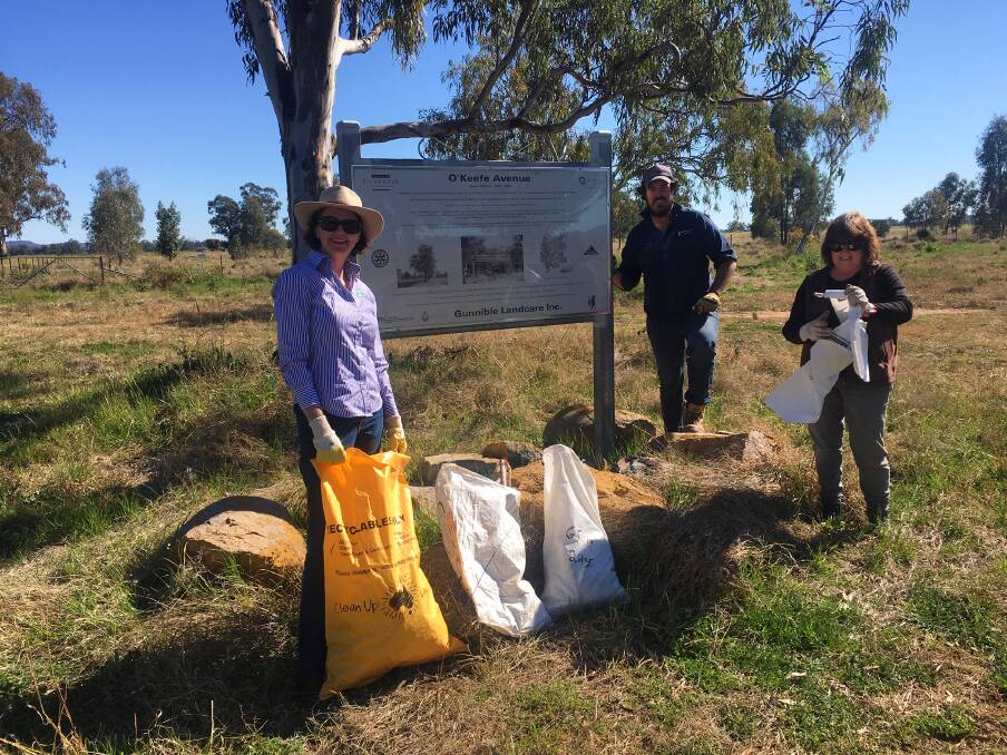 Gunnible Landcare's Lincoln Stewart and Donna McIlveen, right, collect rubbish with Tamworth Regional Landcare's Penny Milson.
