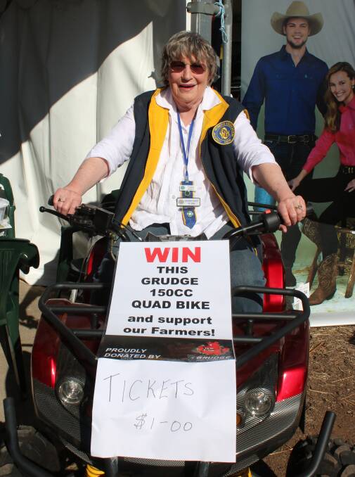 Emerald Hill CWA president Yvonne Argent on the donated quad bike, which is being raffled for drought relief.