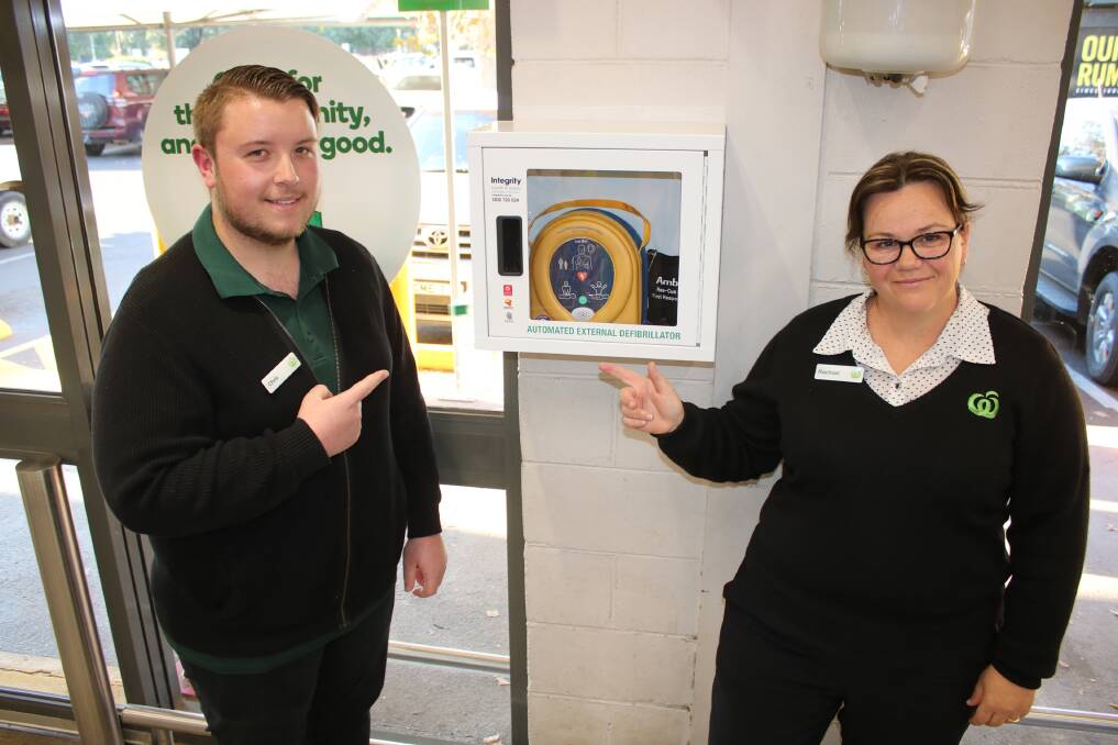 Chris Faint and Rachael Davis point out the new defibrillator, which is near the service desk at Woolworths Gunnedah.