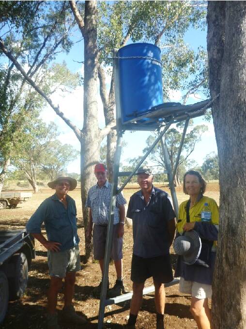 GULG's Bruce Higham and Malcolm Heath with Wayne and Ingrid Yeo at their Emerald Hill property where a Blinky Drinker was recently installed. Photo: Rod Browne, GULG