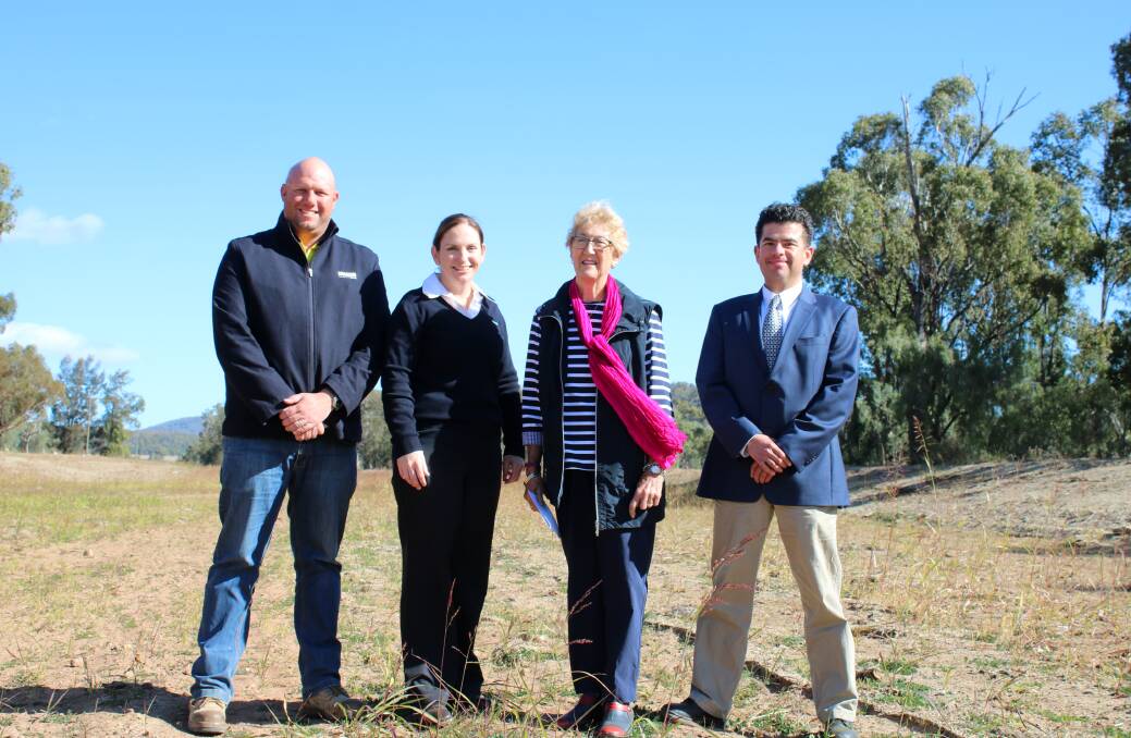 Daracon's Adam King, council's Carolyn Hunt and Gae Swain and Office of Environment and Heritage's Ivan Rivas Acosta at the downstream end of the flood mitigation channel. 