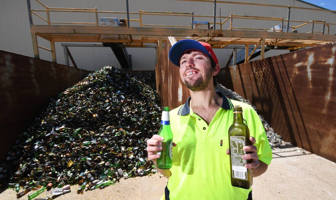 Gunnedah Recyclit employee Jamie Hinton with some of the bottles, which have been placed in kerbside recycling bins. Photo: Gareth Gardner
