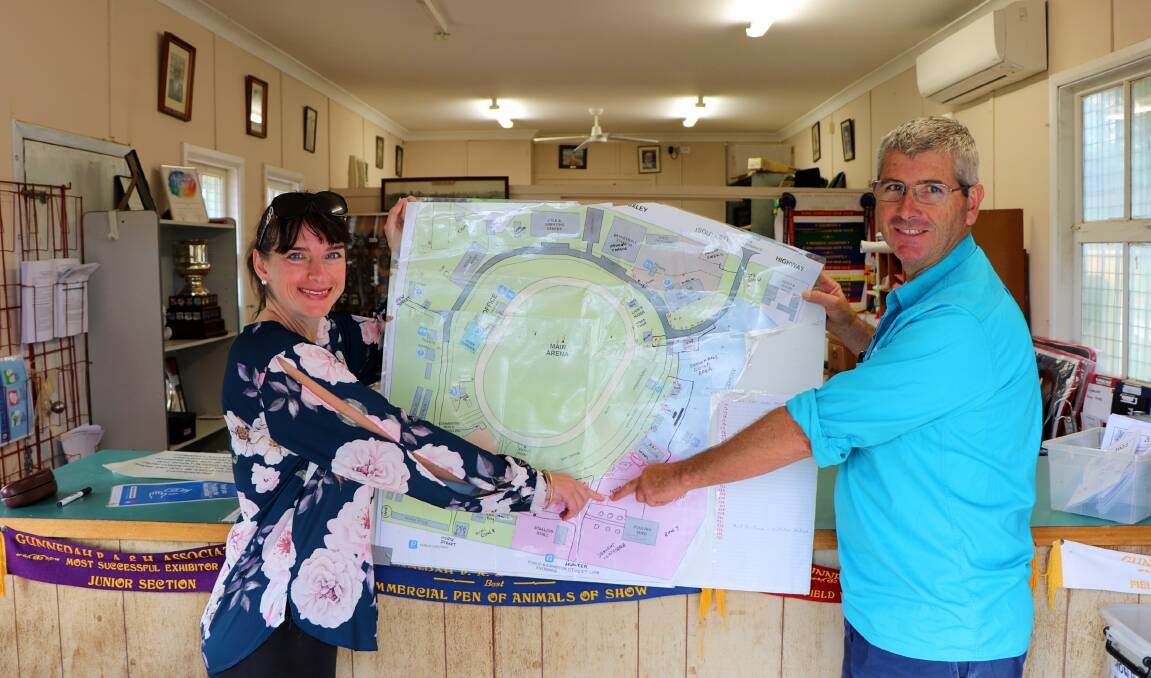 The Gunnedah Show Society's office is a hub of activity as the show approaches. Pictured are secretary Gemma Small and publicity officer George Truman with a marked map of the showground, which will be filled with activities and events from April 1-3.
