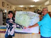 The Gunnedah Show Society's office is a hub of activity as the show approaches. Pictured are secretary Gemma Small and publicity officer George Truman with a marked map of the showground, which will be filled with activities and events from April 1-3.