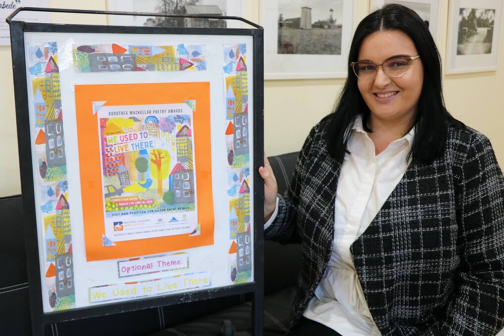 Dorothea Mackellar Poetry Awards officer Brittany Riley with the thematic poster for this year's competition. It was designed by local talent and former NVI employee Alyssa Barwick.