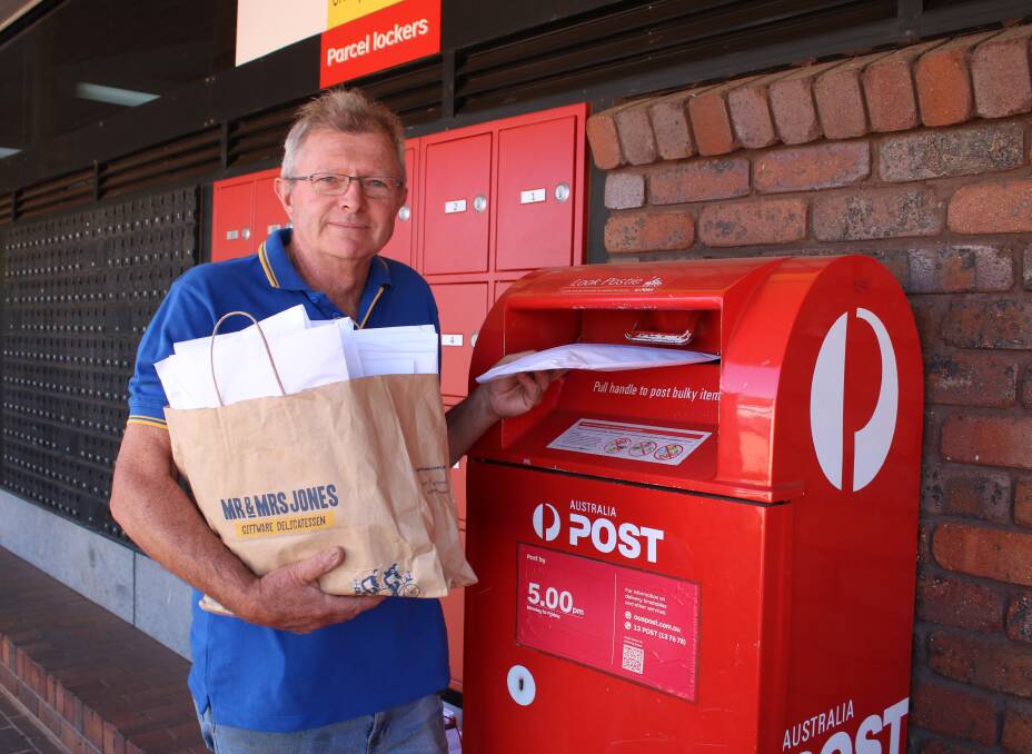 Rotary Club of Gunnedah West president Mark Kesby ready to post the letters to farmers written by Lane Cove kids.