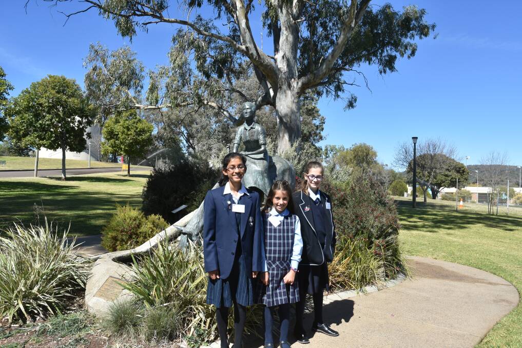 This photo of poetry award recipients in front of the monument in 2017 depicts the backdrop before the pool complex was upgraded.